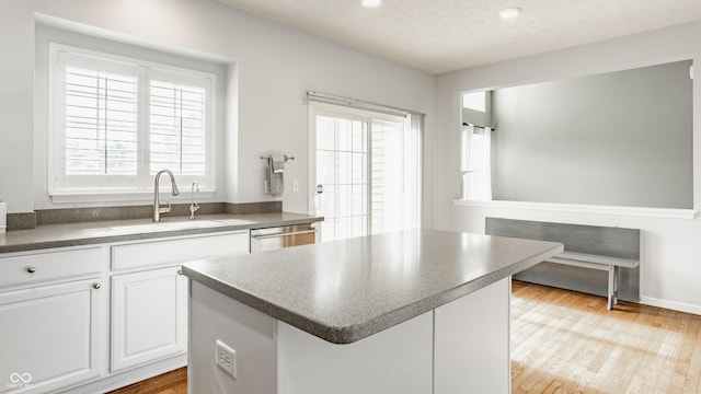 11761 Boothbay Ln, Fishers, IN 46037 - kitchen featuring dark countertops, a center island, white cabinetry, recessed lighting, and dishwasher