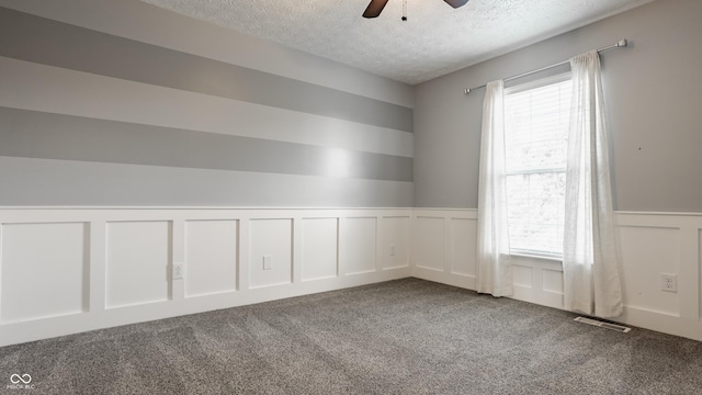11761 Boothbay Ln, Fishers, IN 46037 - carpeted empty room featuring a decorative wall, a textured ceiling, healthy amount of natural light, a wainscoted wall, and a ceiling fan