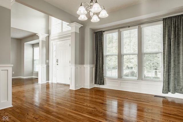 11761 Boothbay Ln, Fishers, IN 46037 - spare room featuring wood finished floors, healthy amount of natural light, a decorative wall, and a wainscoted wall