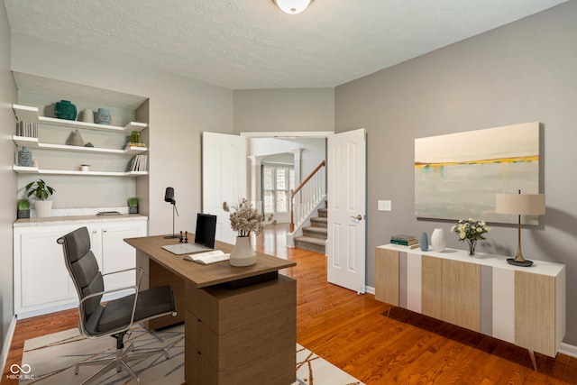 11761 Boothbay Ln, Fishers, IN 46037 - office with light wood-style flooring and a textured ceiling