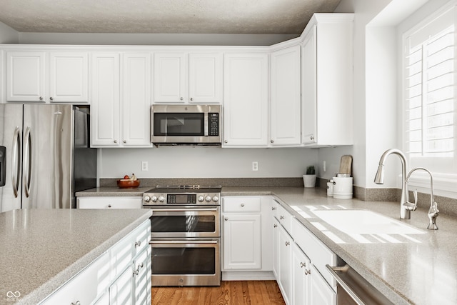 11761 Boothbay Ln, Fishers, IN 46037 - kitchen with appliances with stainless steel finishes and white cabinets
