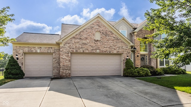 11761 Boothbay Ln, Fishers, IN 46037 - traditional-style house with concrete driveway, brick siding, a garage, and a shingled roof