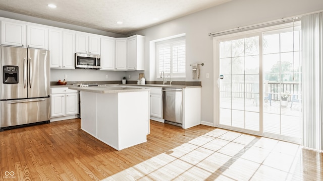 11761 Boothbay Ln, Fishers, IN 46037 - kitchen featuring stainless steel appliances, recessed lighting, white cabinetry, a kitchen island, and light wood-type flooring