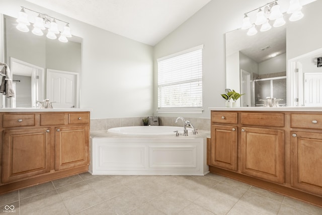 11761 Boothbay Ln, Fishers, IN 46037 - bathroom with lofted ceiling, a shower stall, a bath, vanity, and tile patterned floors