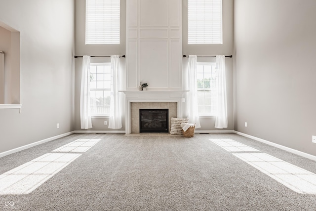 11761 Boothbay Ln, Fishers, IN 46037 - unfurnished living room with a high ceiling, carpet floors, healthy amount of natural light, and a fireplace