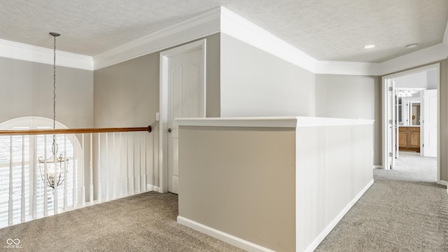 11761 Boothbay Ln, Fishers, IN 46037 - hallway with a chandelier, carpet flooring, a textured ceiling, and ornamental molding