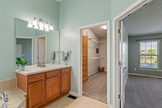 11761 Boothbay Ln, Fishers, IN 46037 - full bathroom with vanity, a walk in closet, a tub to relax in, and tile patterned floors