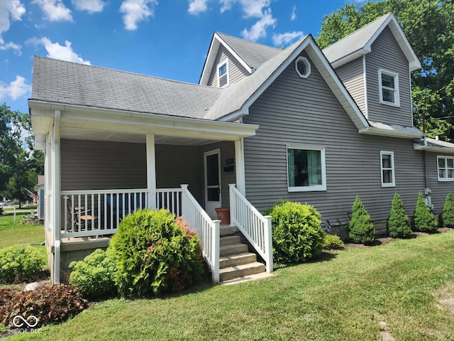 201 N Leland St, Fortville, IN 46040 - view of front facade featuring a front yard, a shingled roof, and a porch