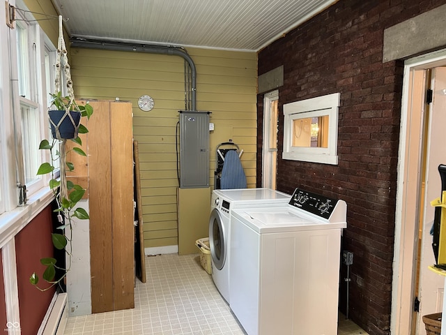 519 E Wabash Ave, Crawfordsville, IN 47933 - washroom featuring electric panel, independent washer and dryer, wooden walls, light tile patterned flooring, and brick wall