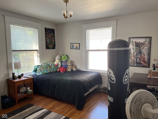 519 E Wabash Ave, Crawfordsville, IN 47933 - bedroom featuring wood finished floors and a chandelier