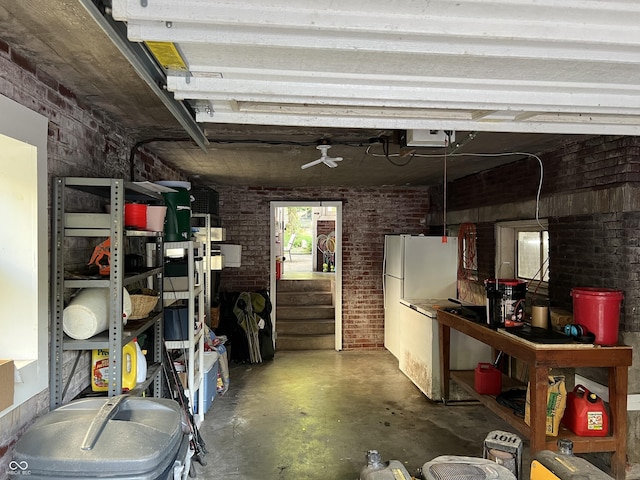 519 E Wabash Ave, Crawfordsville, IN 47933 - garage with a garage door opener, a ceiling fan, and freestanding refrigerator
