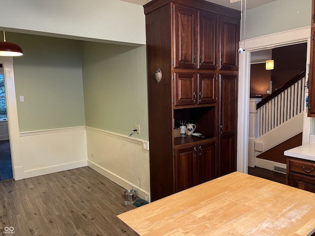 519 E Wabash Ave, Crawfordsville, IN 47933 - bar featuring dark wood-style floors, stairs, and wainscoting