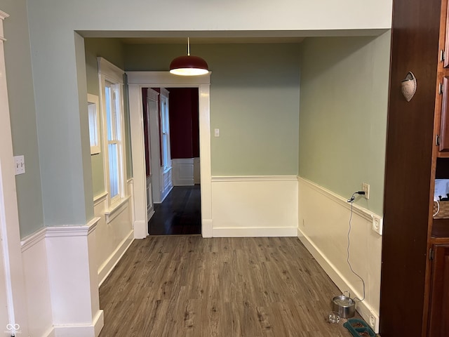 519 E Wabash Ave, Crawfordsville, IN 47933 - hallway with dark wood-style floors and a wainscoted wall
