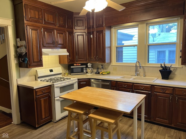 519 E Wabash Ave, Crawfordsville, IN 47933 - kitchen with appliances with stainless steel finishes, under cabinet range hood, light countertops, and tasteful backsplash