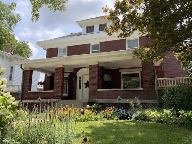 519 E Wabash Ave, Crawfordsville, IN 47933 - american foursquare style home featuring brick siding and covered porch