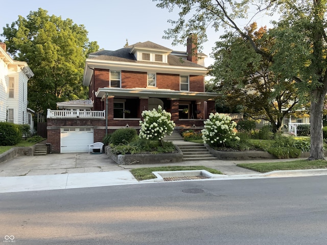 519 E Wabash Ave, Crawfordsville, IN 47933 - traditional style home with brick siding, an attached garage, driveway, a chimney, and covered porch