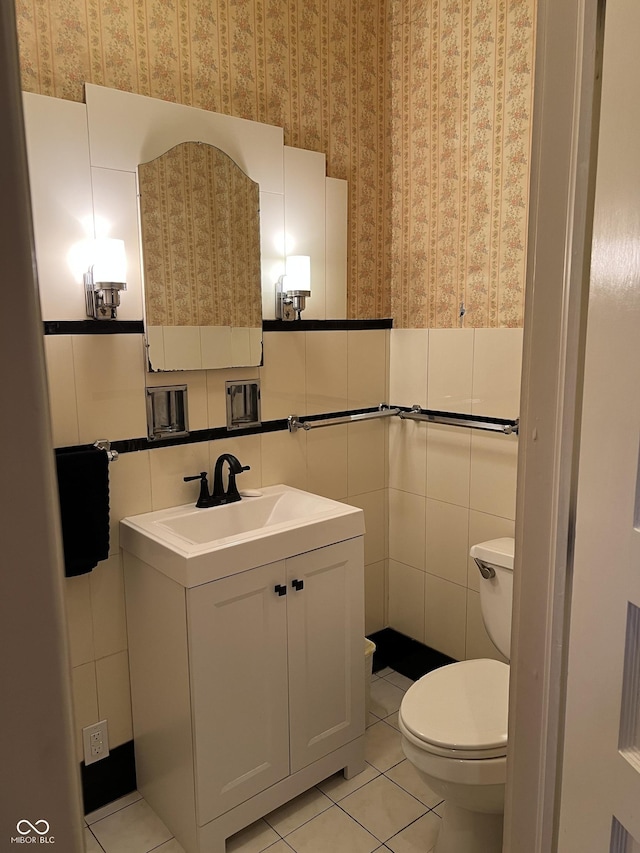 519 E Wabash Ave, Crawfordsville, IN 47933 - bathroom with wallpapered walls, vanity, tile patterned flooring, and tile walls