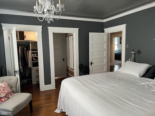 519 E Wabash Ave, Crawfordsville, IN 47933 - bedroom featuring a walk in closet, a chandelier, wood finished floors, and ornamental molding