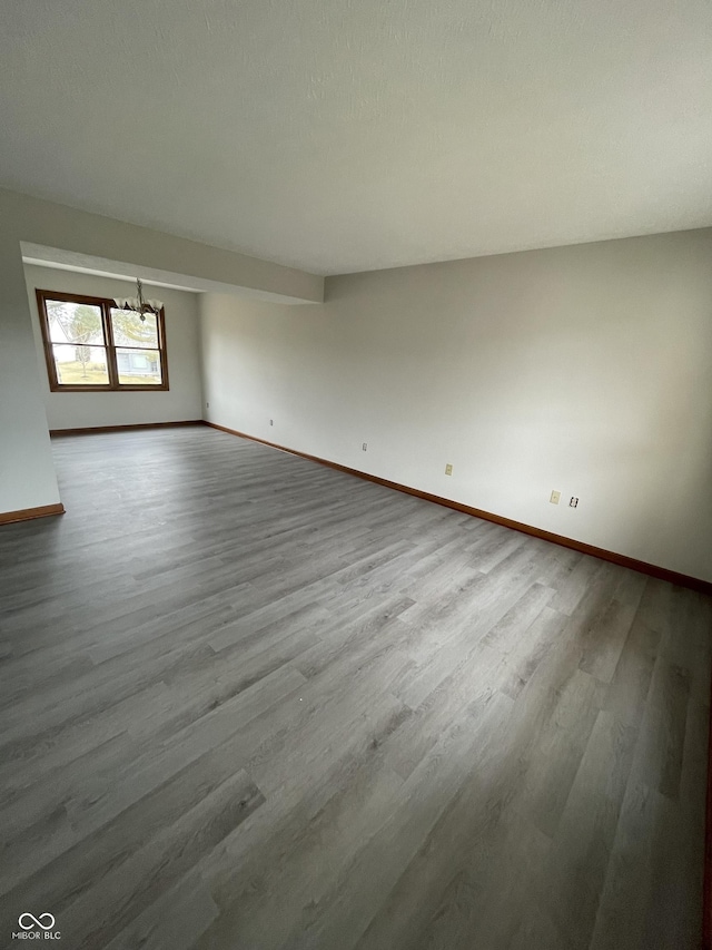 2068 Suda Dr, Carmel, IN 46280 - empty room with wood finished floors and a chandelier