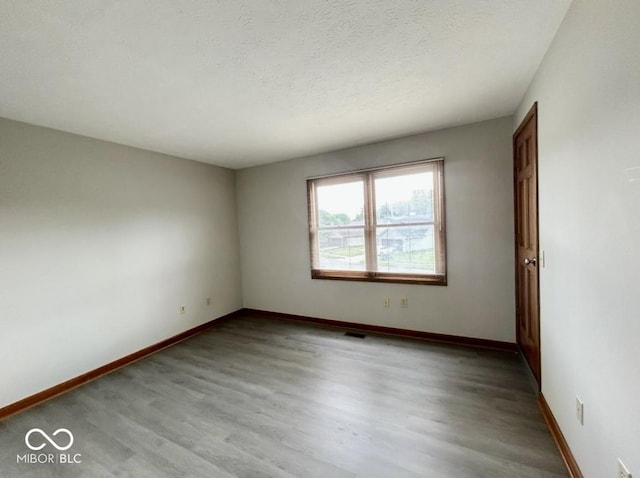 2068 Suda Dr, Carmel, IN 46280 - spare room featuring wood finished floors and a textured ceiling