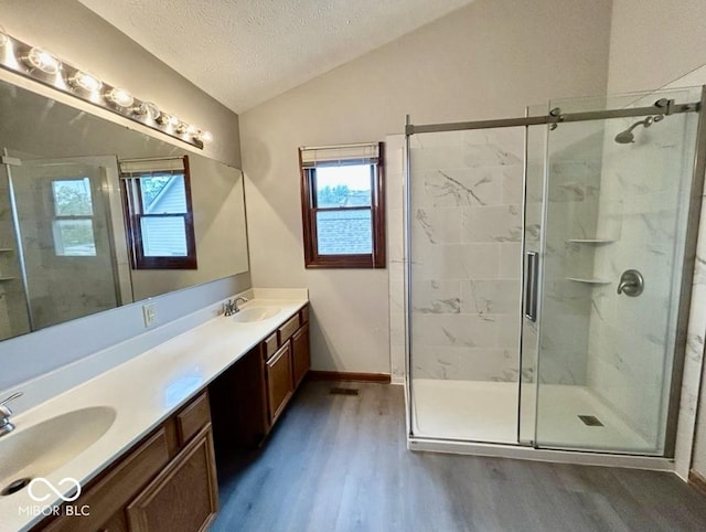2068 Suda Dr, Carmel, IN 46280 - full bath with wood finished floors, vaulted ceiling, a stall shower, double vanity, and a textured ceiling