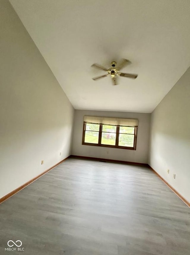 2068 Suda Dr, Carmel, IN 46280 - unfurnished room featuring wood finished floors, ceiling fan, and lofted ceiling