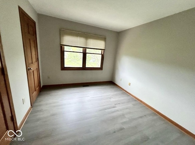 2068 Suda Dr, Carmel, IN 46280 - unfurnished bedroom with baseboards and light wood-type flooring
