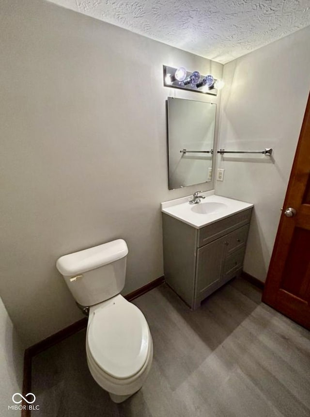 2068 Suda Dr, Carmel, IN 46280 - half bath featuring vanity, a textured ceiling, and wood finished floors