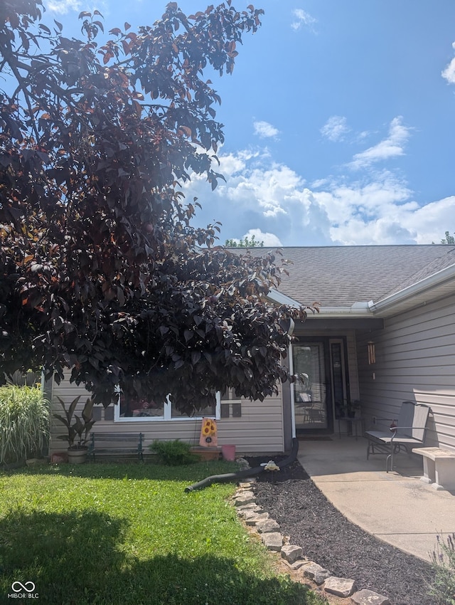 4124 Lofton Dr, Lafayette, IN 47909 - back of property featuring a lawn, a patio area, and a shingled roof