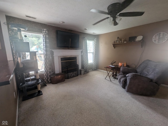 4124 Lofton Dr, Lafayette, IN 47909 - living room featuring carpet flooring, a textured ceiling, a ceiling fan, plenty of natural light, and a fireplace with flush hearth
