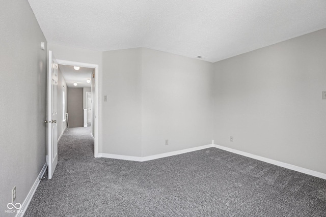 12632 Endurance Dr, Fishers, IN 46037 - spare room featuring dark colored carpet and a textured ceiling