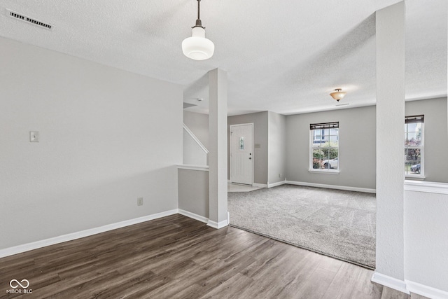 12632 Endurance Dr, Fishers, IN 46037 - empty room featuring wood finished floors, a textured ceiling, and stairs