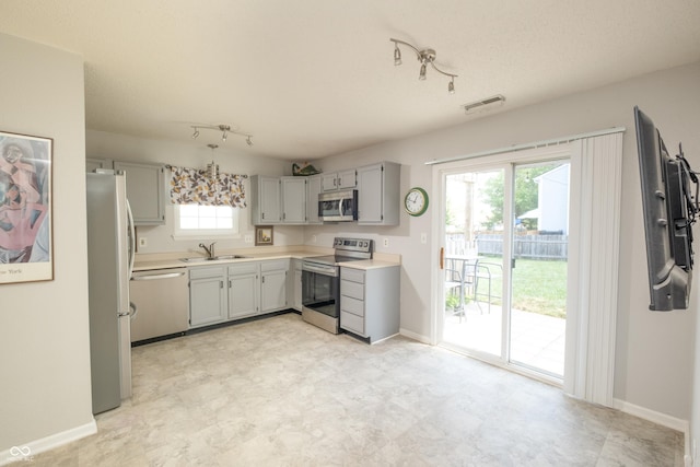 10301 Cerulean Dr, Noblesville, IN 46060 - kitchen with stainless steel appliances, gray cabinetry, light floors, and light countertops