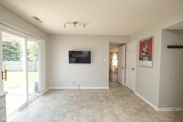10301 Cerulean Dr, Noblesville, IN 46060 - unfurnished living room featuring a textured ceiling and baseboards