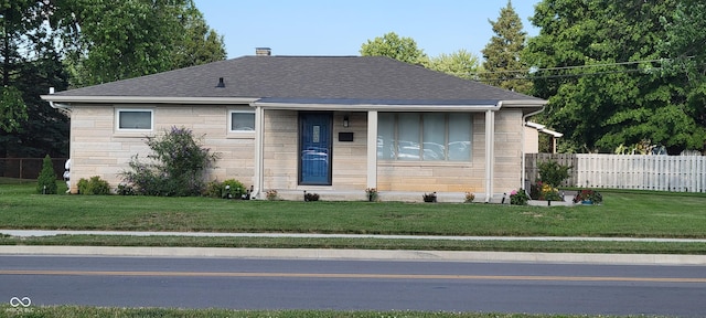 2611 Taylor Rd, Columbus, IN 47203 - view of front of house featuring stone siding, roof with shingles, and a chimney