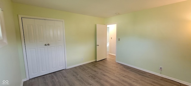 2611 Taylor Rd, Columbus, IN 47203 - unfurnished bedroom with wood finished floors and a closet