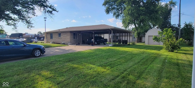 2611 Taylor Rd, Columbus, IN 47203 - rear view of property with a yard, concrete driveway, an outbuilding, and stone siding