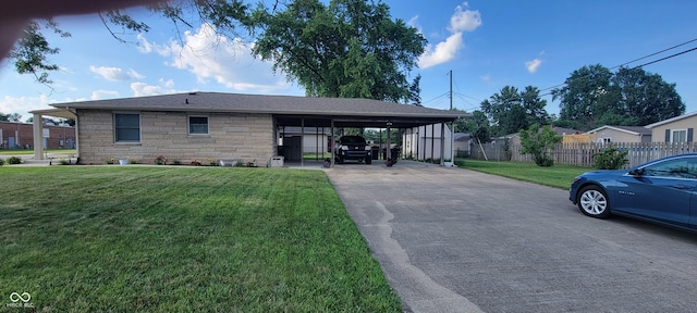2611 Taylor Rd, Columbus, IN 47203 - view of front of property featuring stone siding, concrete driveway, and an attached carport