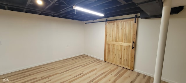 2611 Taylor Rd, Columbus, IN 47203 - finished below grade area featuring a barn door and wood finished floors