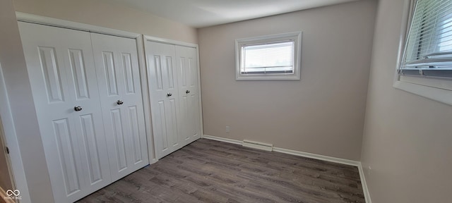 2611 Taylor Rd, Columbus, IN 47203 - unfurnished bedroom featuring multiple closets and dark wood-type flooring