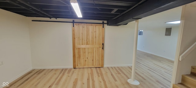 2611 Taylor Rd, Columbus, IN 47203 - finished basement featuring wood finished floors, stairs, and a barn door