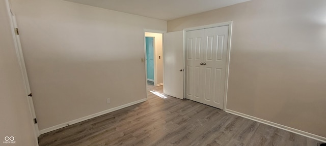 2611 Taylor Rd, Columbus, IN 47203 - unfurnished bedroom featuring wood finished floors and a closet