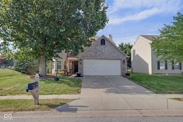8850 Tanner Dr, Fishers, IN 46038 - view of front of property featuring brick siding, a garage, driveway, and a front yard