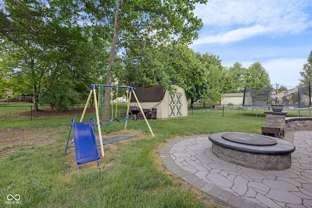 8850 Tanner Dr, Fishers, IN 46038 - view of playground featuring a trampoline, a storage unit, a fenced backyard, and an outdoor fire pit