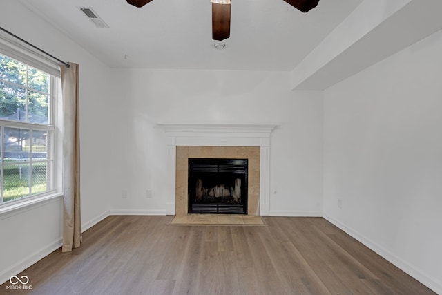 8850 Tanner Dr, Fishers, IN 46038 - unfurnished living room featuring ceiling fan, wood finished floors, and a tile fireplace