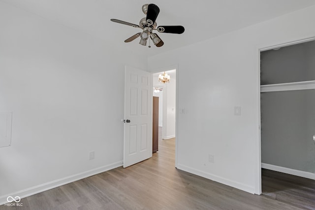 8850 Tanner Dr, Fishers, IN 46038 - unfurnished bedroom featuring wood finished floors, a closet, a chandelier, and ceiling fan