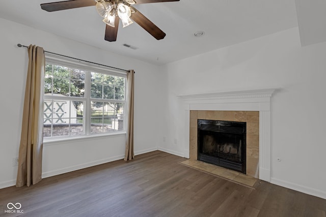8850 Tanner Dr, Fishers, IN 46038 - unfurnished living room with wood finished floors, a tiled fireplace, and ceiling fan