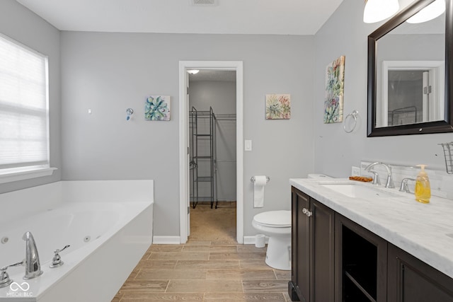8850 Tanner Dr, Fishers, IN 46038 - full bathroom with vanity, a tub with jets, plenty of natural light, and wood finished floors