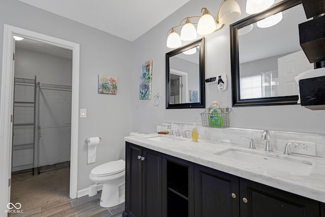 8850 Tanner Dr, Fishers, IN 46038 - full bathroom featuring double vanity, wood finished floors, and a spacious closet