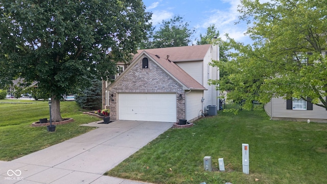 8850 Tanner Dr, Fishers, IN 46038 - view of front of property with a front yard, driveway, brick siding, an attached garage, and a chimney
